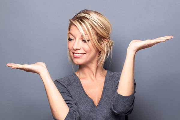 smiling-blonde-woman-on-gray-background