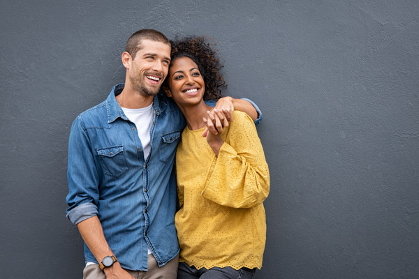 diverse-couple-laughing-holding-hands